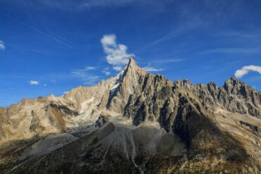 Home Stunning view of rugged peaks in the French Alps under a clear blue sky.